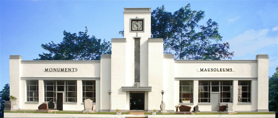 The Benchmark Monument building on East 11th Street in Tulsa, with MONUMENTS and MAUSOLEUMS lettered across the facade and monuments displayed on the lawn
