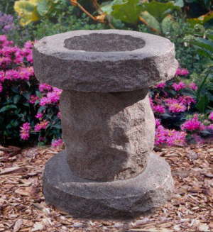 Carved stone birdbath on a pedestal